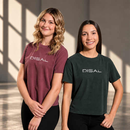 Models are wearing washed maroon crop tee with ivory logo and Washed black tee with ivory logo